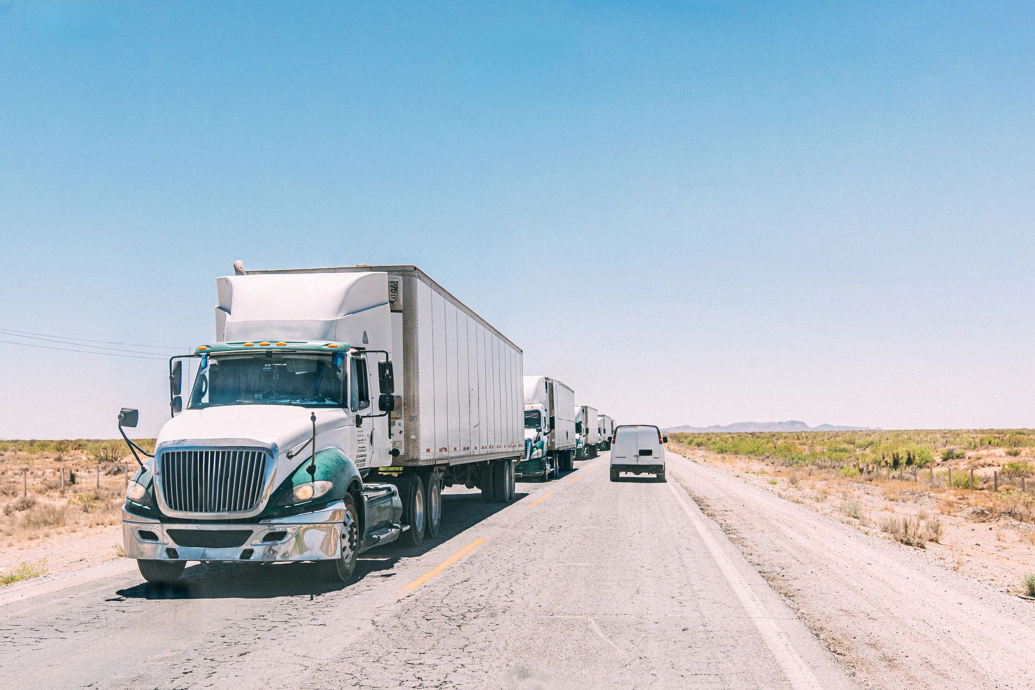 Semi truck hauling on desert roadway