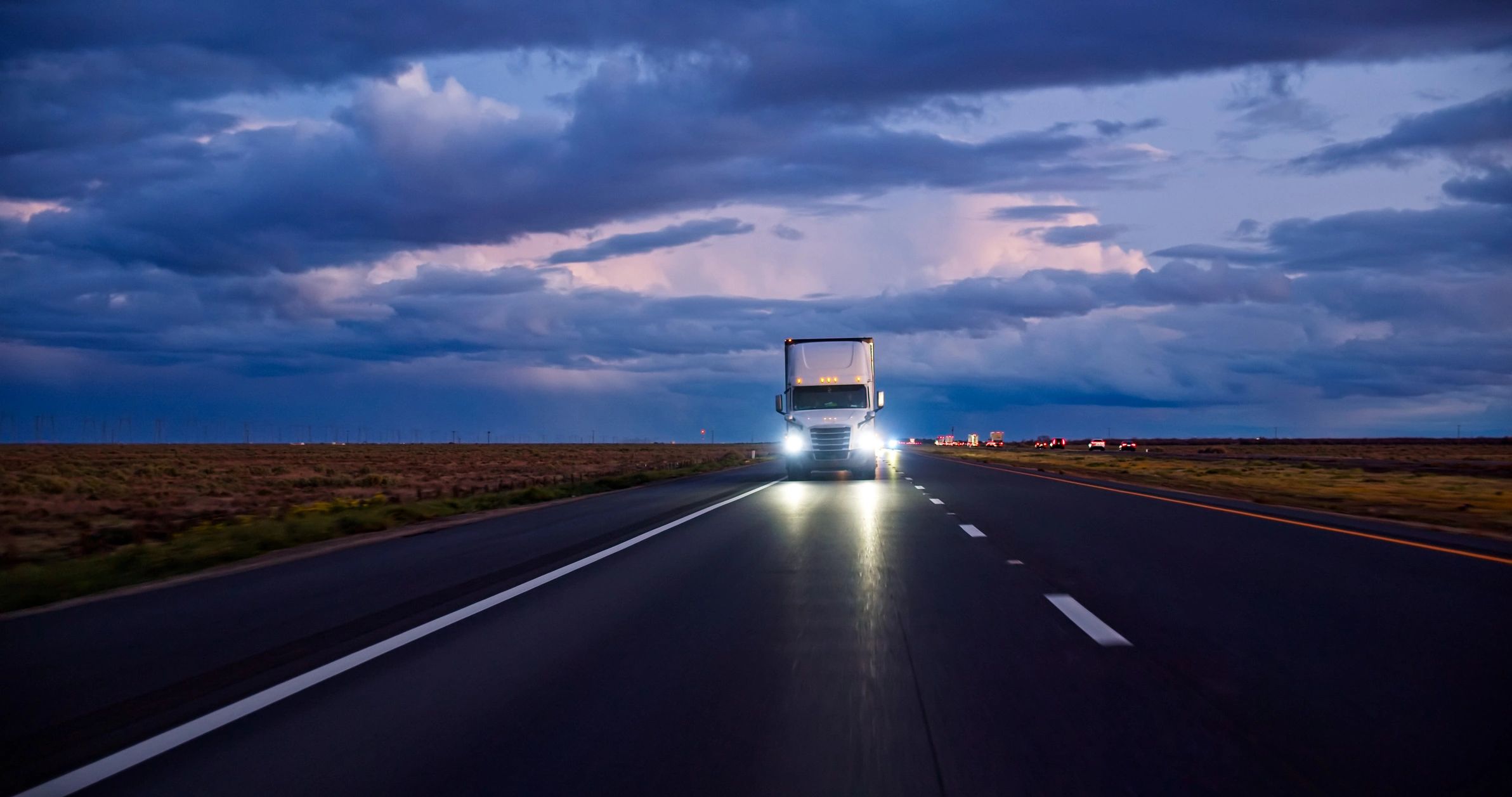 Truck traveling at sunset
