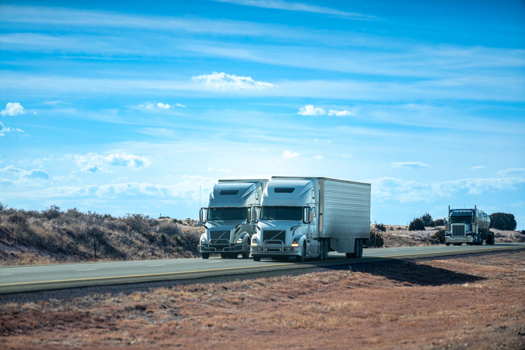 Commercial truck fleet parked in arid landscape